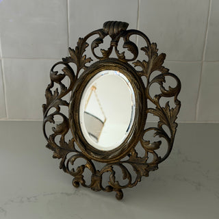 Ornate brass flourish vanity mirror